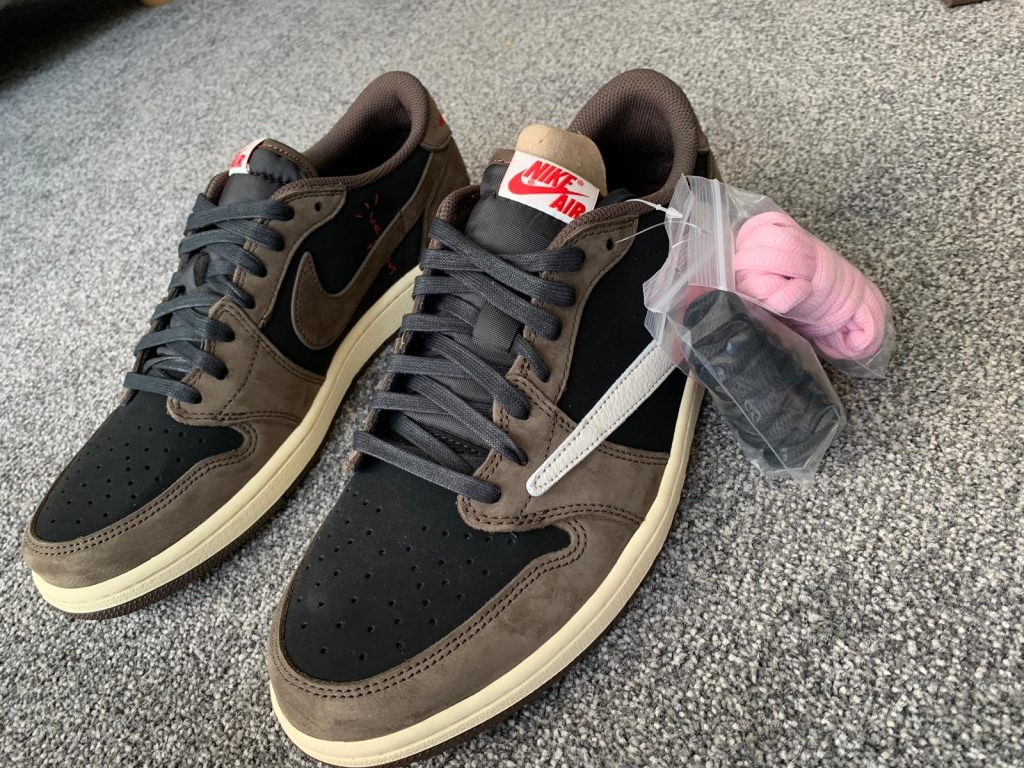 Close-up of Travis Scott Air Jordan 1 Low Mocha showing brown suede overlays and black toe box